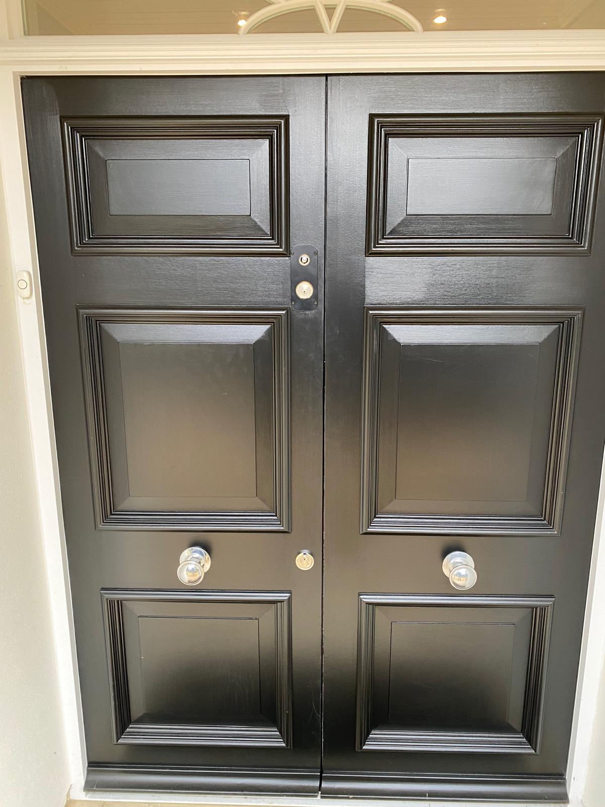 Newly installed black double front doors
