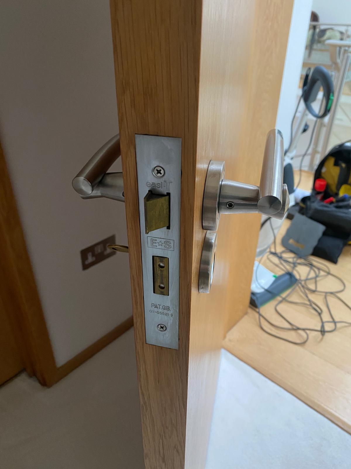 Brass thumb-turn deadbolt fitted on a blue front door